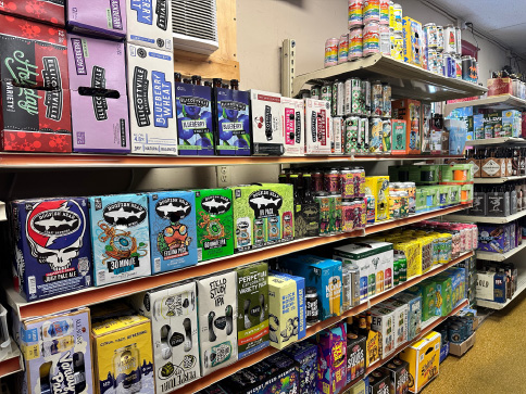 A large selection of various beer products on shelves inside Beverage Shop Beer Distributor in Erie, PA is shown here.