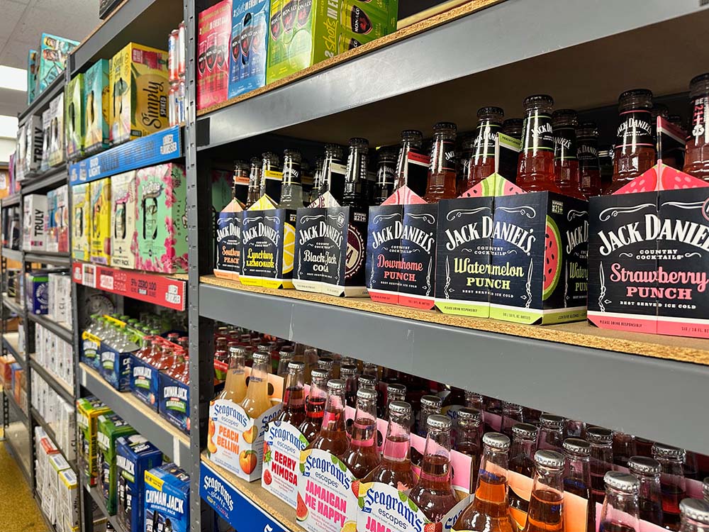 Shelves filled with many different malt alcohol beverages including Jack Daniels malt beverage, Seagrams malt beverage, Cayman Jack beverages and Arizona Hard Teas.